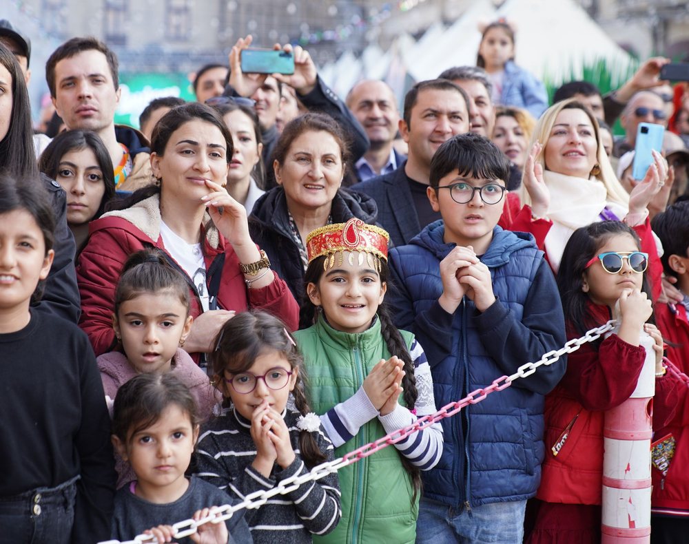 Diverse group of adults and children at an outdoor festival